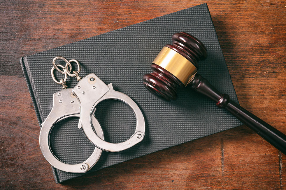 handcuffs handcuff and wooden gavel